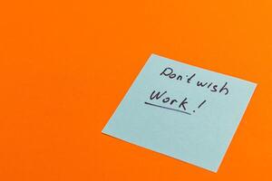 Note expressing desire to avoid work on bright orange background photo