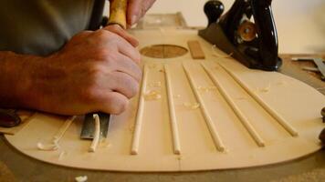 Luthier making a guitar structure with a chisel video