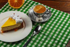 Citrus cheesecake with espresso on a cozy table setting photo