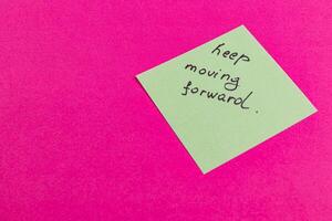 Motivational note encouraging perseverance on a bright background photo