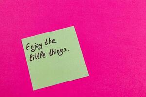 Inspirational. note on pink background cherish small joys photo