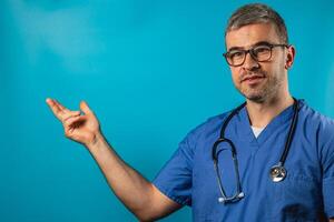 Doctor in blue scrubs explaining medical concepts against a blue background photo