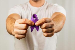 Supporting awareness with a purple ribbon in hands during an advocacy event photo