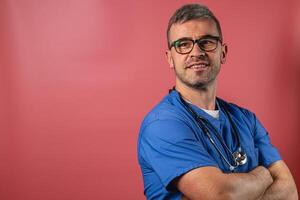 Smiling male healthcare professional in scrubs against a colorful background photo