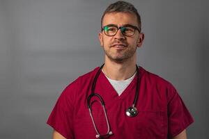 Medical professional wearing scrubs and stethoscope in clinic setting photo