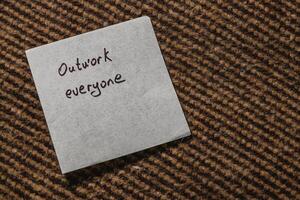 Reminder note encouraging teamwork and collaboration in a workspace photo