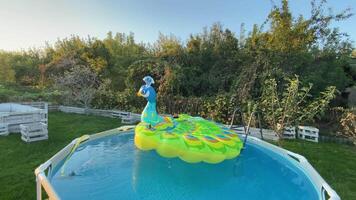 Water from the hose is collected in a frame pool for swimming and relaxing by the water video