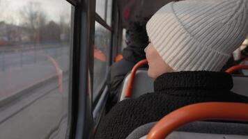 Passenger in a White Hat Looking Out the Window of a Moving Tram video