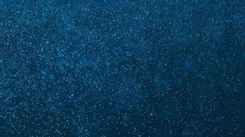 Deep blue starry sky filled with countless twinkling stars. Some emit a radiant glow, creating a magical cosmic scene. The shimmering background resembles a vast galaxy or an abstract glittering space video