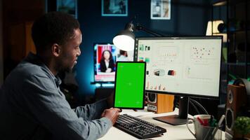 Young guy examining funds for a program and holding tablet with mockup, studying finances and accounting management on a software. Male specialist doing remote work for a startup. Camera A. video