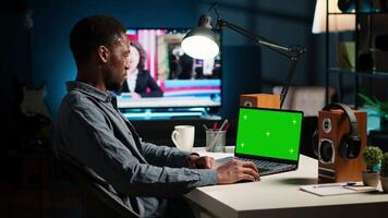 Self employed person checking financial graphs on chroma key screen, researching and sharing insight. Remote worker comparing business graphic economic figures, creating a strategy. Camera B. video