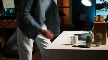 African American freelancer researching data driven topics at his home workstation, planning work schedule and completing project tasks. Managing job from a comfortable setup. Camera B. video