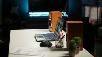 Empty yet inviting home office in a contemporary illuminated apartment. Wooden floors, modern furniture and decorative plants creating a cozy workspace for studying or working indoors. video