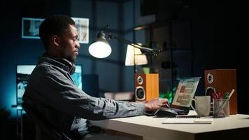 Financial advisor talks to his team on phone call at home office, obtain new business funding from shareholders. Young man doing remote work to increase revenue and reduce cost. Camera A. video