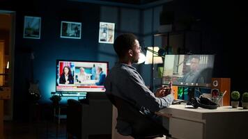 African American young guy meeting with his boss to discuss task completion, enjoying remote job from the comfort of his modern loft. Waving on a call online, briefing session. Camera A. video