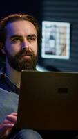 Vertical Man at home scared by troubling events broadcasted on TV, rushing to leave house. Person appalled by imminent danger upsetting breaking news story on TV, running out of fear, camera A video