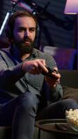 Vertical Satisfied gamer bragging after finally defeating all enemies while playing on gaming console. Pleased player congratulating himself after winning videogame using controller, camera A video
