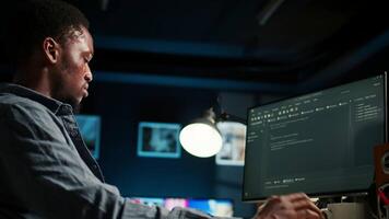 Developer enters binary data on terminal panel while he establishes html code. Software engineer working from home on troubleshooting with programming language, encryption. Camera A. video