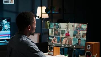 Colleagues attending a virtual webinar on pc from their homes, using a laptop for an online meeting call. Young african american man engrossed in the discussion, conferencing. Camera B. video