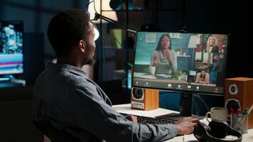 African american remote worker attending a web meeting call in a living room. Smiling black man engages in virtual communication to discuss about executive matters from home office. Camera B. video