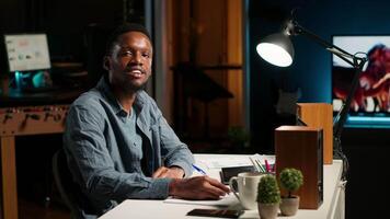 POV waving from his personal office, black man participates in online call meeting. Young conference speaker addressing business topics with attendees, web teleconference chat. Camera B. video