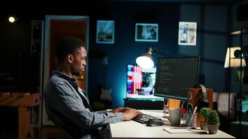 African american man working on PC to write code and programming in artificial intelligence and deep learning. Male IT engineer using pc to ensure cyber security, neural network. Camera A. video