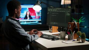 African american man working on PC to write code and programming in artificial intelligence and deep learning. Male IT engineer using pc to ensure cyber security, neural network. Camera B. video