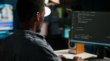 Male developer entering binary data on terminal panel while writing html code. Software engineer working on troubleshooting with programming language, internet and server security. Camera B. video
