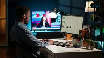 Network analyst studying digital commerce progression reports on computer, working at home to boost earnings and gain shareholder backing. Specialist analyzes company information. Camera A. video