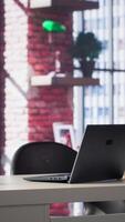 Vertical Empty desk in a luxurious loft apartment with a modern minimalist design. Bright spacious home office features sleek furniture, panoramic windows and an elegant ambiance perfect for creativity. video