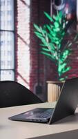 Vertical Clean open desk in a luxurious home office loft surrounded by panoramic windows and sleek furniture, the modern design creates a spacious artistic ambiance perfect for work and creativity. video