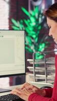 Vertical Mature woman interacting with a virtual assistant on her computer at home desktop, responses and smart automation to improve online communication. Data driven solutions. Camera A. video