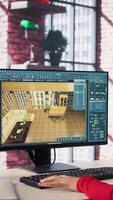 Vertical Woman arranging virtual assets in a architectural software on dual monitors, creating a detailed 3D render of a floor plan. Freelancer uses program for computer aided interior design. Camera B. video