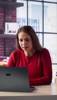 Vertical Furious disappointed woman ending the call meeting by closing the pc, getting angry and displeased with lack of productivity. Mature leader screams on web conference. Camera B. video