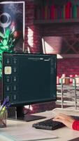 Vertical IT engineer at desk generating code algorithm with AI powered chat, programming on monitor and writing lines of code. Woman debugging software on a terminal window interface. Camera B. video