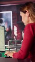 Vertical AI chatbot application displayed on a desktop computer for solutions, helping streamline text based tasks. Woman showcases innovation, automation and machine learning for seamless support. Camera A. video