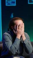 Vertical Furious sports fan in disbelief during match broadcast after own team fails to score, expressing anger. Enraged man acting childish in frustration after seeing favorite club commit blunder, camera A video
