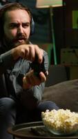 Vertical Gamer feeling overjoyed after winning videogame level, screaming in excitement. Ecstatic man at home yelling from joy after achieving victory while playing on gaming console, camera A video