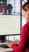 Vertical Mature woman interacting with a virtual assistant on her computer at home desktop, responses and smart automation to improve online communication. Data driven solutions. Camera B. video