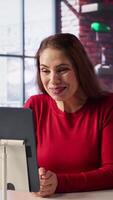 Vertical Excited woman joining online lesson to work on new skills from home desk, attending web conference call and watching lecture from her loft. Adult participates at a virtual training class. Camera B. video