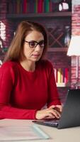 Vertical Stressed woman at home desk battling job burnout and exhaustion, experiences frustration due to work life and being drained. Freelancer feels unmotivated, worried and overwhelmed. Camera B. video