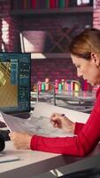 Vertical Remote worker in creative office uses CAD software and blueprints plan, design a house interior and provides a user interface for virtual home customization. Detailed architectural layout. Camera B. video