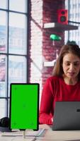 Vertical Woman organizing and planning activities on the agenda next to chroma key, overseeing time management for the schedule by using online tools as weekly planner and digital calendar. Camera B. video