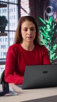Vertical Confident woman solving her tasks on a freelance platform at home, answering emails and multitasking. Mature worker staying connected and enjoying the flexibility of working remotely. Camera B. video