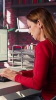 Vertical Freelancer typing commands into a futuristic AI chatbot to help solve tasks, artificial intelligence demonstrates the power of automation and virtual assistance for efficiency. Camera B. video