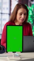 Vertical Woman organizing and planning activities on the agenda next to chroma key, overseeing time management for the schedule by using online tools as weekly planner and digital calendar. Camera A. video