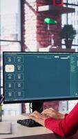 Vertical Mature developer coding cloud computing with AI chatbot on pc, working from her home and focuses on the software development process for productivity and innovation. Prompts for code. Camera B. video
