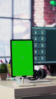 Vertical Mature adult utilizes a digital AI tool on web interface next to green screen, remote work. Artificial intelligence powered interface simplifies communication and increases efficiency. Camera A. video