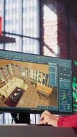 Vertical Woman at home creating a 3D render of an apartment interior layout, utilizing architectural software. Developer uses digital tools to decorate detailed home design, placing assets. Camera A. video