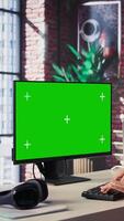 Vertical Confident woman solves freelancing tasks at copy space desktop, browsing the internet pages at her home office. Mature focused person self employed doing her job remotely. Camera B. video